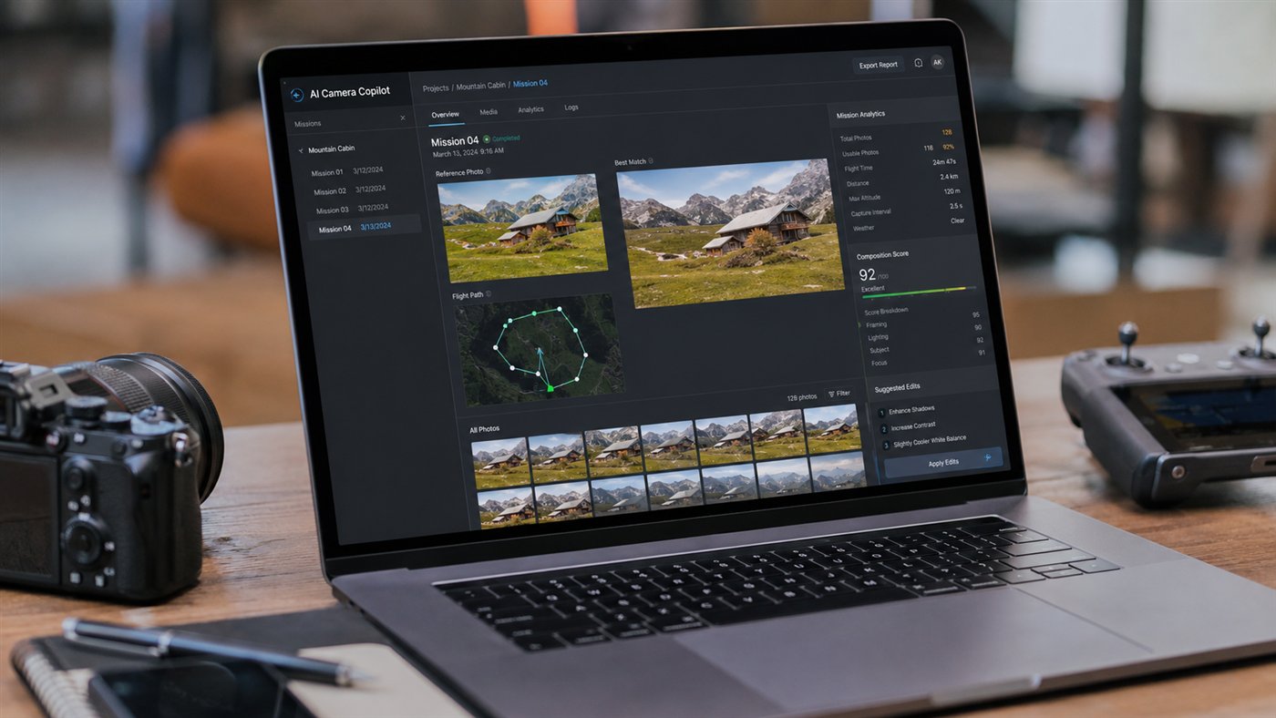 The copilot's desktop review desk on a laptop, beside a pro camera body and drone controller — missions, flight paths and suggested edits in one place